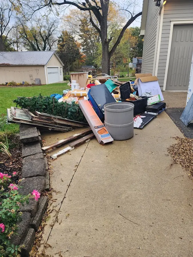 Dumpster being loaded with debris for Estate Cleanout Dumpster Rental in Clarksburg